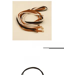 Detail of woven braided waist belt in beige, tan and dark brown with gold metal tips