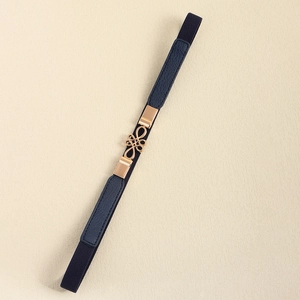 Detail of navy elastic belt with golden alloy knot buckle and lychee grain leather