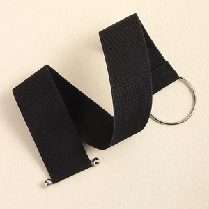 Detail view of black elastic corset belt featuring silver metal ring and bead closure