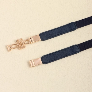 Detail view of navy elastic belt featuring golden Chinese knot metal buckle and PU texture