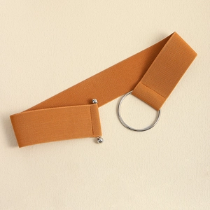 Detail of orange-brown elastic waist belt featuring a polished silver metal ring buckle