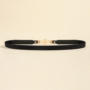 Close-up of heart-shaped gold alloy buckle on a slim black elastic belt for women