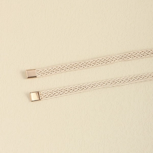 Detail of cream woven waist belts with polished pale gold square metal end caps