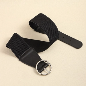 Detail of black wide elastic waist belt featuring a polished silver round metal buckle