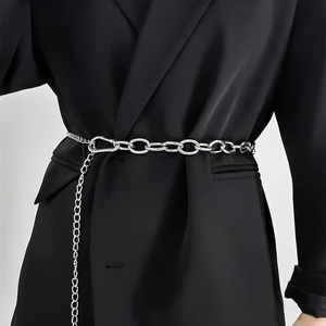 Close-up of silver metal chain belt accessory on a black blazer for stylish outfit detail
