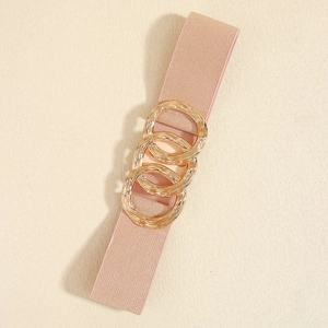 Detail of pink elastic waist belt featuring three interlocking golden circular buckles