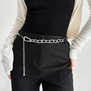 Detail view of silver metal chain belt with oval links and lobster clasp on black dress