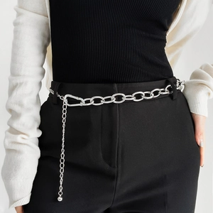 Detail of silver metal link belt with large oval rings and a polished sphere pendant