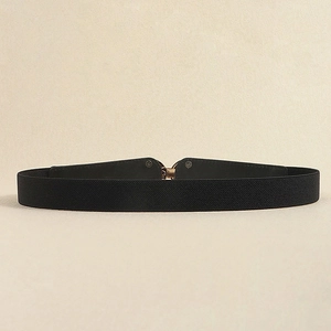 Minimalist black elastic waist belt for dresses with sleek gold metallic buckle closure