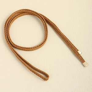 Close-up of hand-woven brown braided waist rope with elegant gold metal tips for dresses
