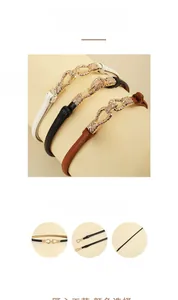 Close-up of thin leather waist belts for women with decorative golden woven metal buckles