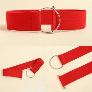 Detail of red wide elastic waist belt featuring a silver metallic O-ring buckle design
