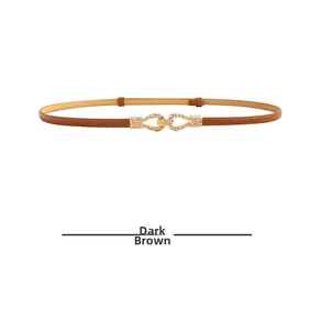 Detail of thin dark brown leather belt featuring a golden braided twist metal buckle