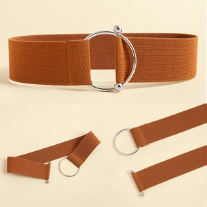 Detail view of caramel elastic waist belt featuring a polished silver metal ring buckle