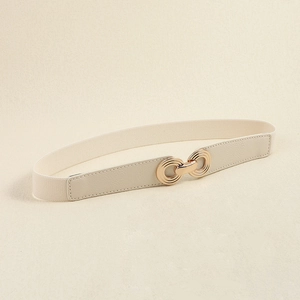 Detail of beige elastic waist belt with gold interlocking double rings and textured leather