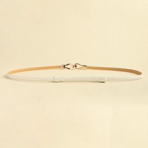 Detail of thin cream leather belt featuring a matte gold geometric twist buckle closure