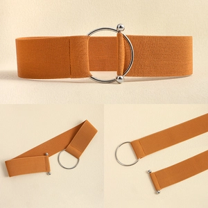 Detail view of bright orange elastic waist belt with silver metal ring buckle and texture
