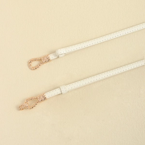 Minimalist white leather belt for dresses featuring elegant rose gold twisted buckle