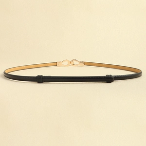 Close-up of slim black leather belt with elegant geometric light gold metal buckle