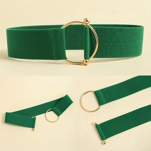 Detail of green elastic waist belt with a stylish gold circular metal ring buckle