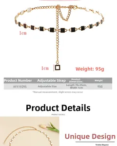 Detail view of gold metal waist chain with black and white square enamel charms