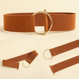 Detail view of caramel elastic waist belt featuring a gold circular interlocking buckle