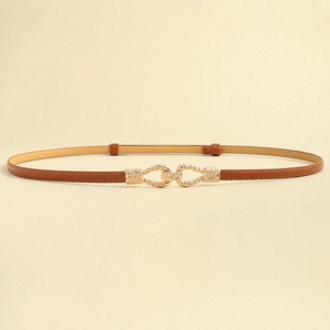 Detailed close-up of golden twisted buckle and dark brown leather belt for dresses