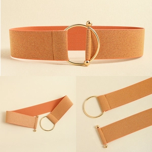Detailed close-up of orange-gold elastic woven belt with circular golden metal buckle