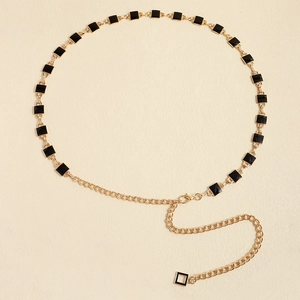 Detail of gold metal waist chain with black square oil drip charms and lobster clasp
