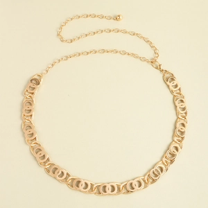 Detail of adjustable golden link chain belt with lobster clasp and round ball pendant