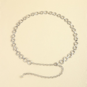 Detail of silver infinity link chain belt featuring adjustable lobster clasp and metal bead