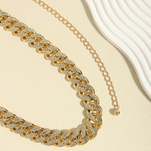 Close-up of gold Cuban waist chain with sparkling rhinestones and adjustable links