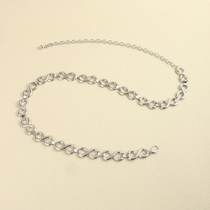 Detailed macro view of silver infinity link chain belt with lobster clasp and adjuster