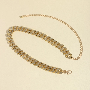 Close-up of golden rhinestone-encrusted Cuban chain with lobster clasp and adjustable link