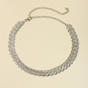 Macro detail of silver Cuban link chain with sparkling rhinestones and adjustable clasp