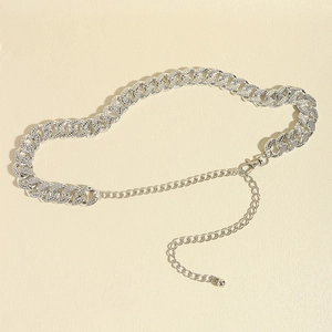 Detailed macro view of silver rhinestone encrusted Cuban link chain belt with lobster clasp