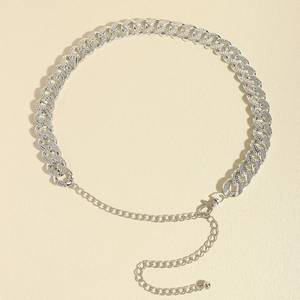 Macro detail of silver Cuban waist chain with rhinestones and lobster clasp closure