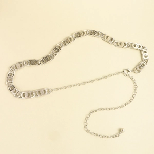 Detailed view of silver chain belt with double rings, lobster clasp and metal ball charm