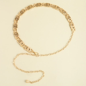 Detail of adjustable gold metal chain belt with lobster clasp and round ball pendant