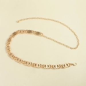 Detailed macro view of high-shine gold chain waist belt with adjustable lobster clasp