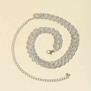 Macro shot of luxury Cuban link chain belt with sparkling rhinestones and lobster clasp