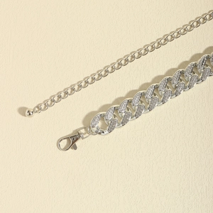 Detail of silver Cuban chain waist belt with shimmering rhinestones and lobster clasp