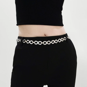 Close-up of a silver infinity link waist chain on a black dress for women
