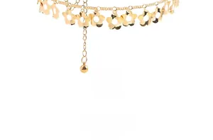 Detailed macro view of gold plum blossom flower pendants with tassels on a metal belt chain