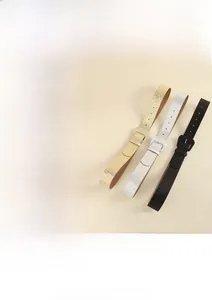 Detailed close-up of three sparkling Y2K fashion belts in pink gold silver and matte black