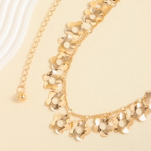 Elegant gold metal chain belt featuring hollow plum flower pendants and smooth tassels