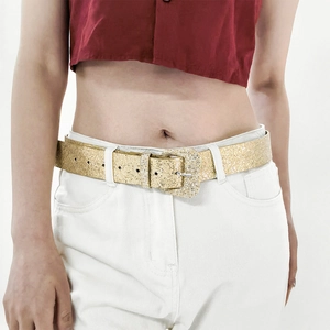 Close-up of golden sequin belt with rhinestone buckle on white jeans for Y2K style
