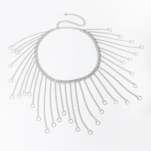 Detailed macro view of silver tassel body chain with round pendants and curb chain design