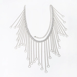Macro detail of silver multilayer body chain with fringed metal loops and tassels