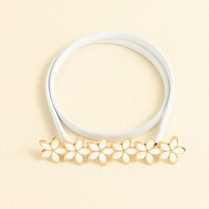 Close-up of white flower buckle with golden edges on an elastic woven belt